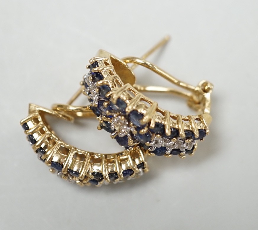 A modern pair of 14k yellow metal, sapphire and diamond cluster set demi-lune earrings, 19mm, gross weight 7.4 grams.
